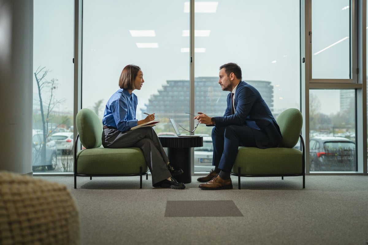 Two professionals in a focused leadership discussion